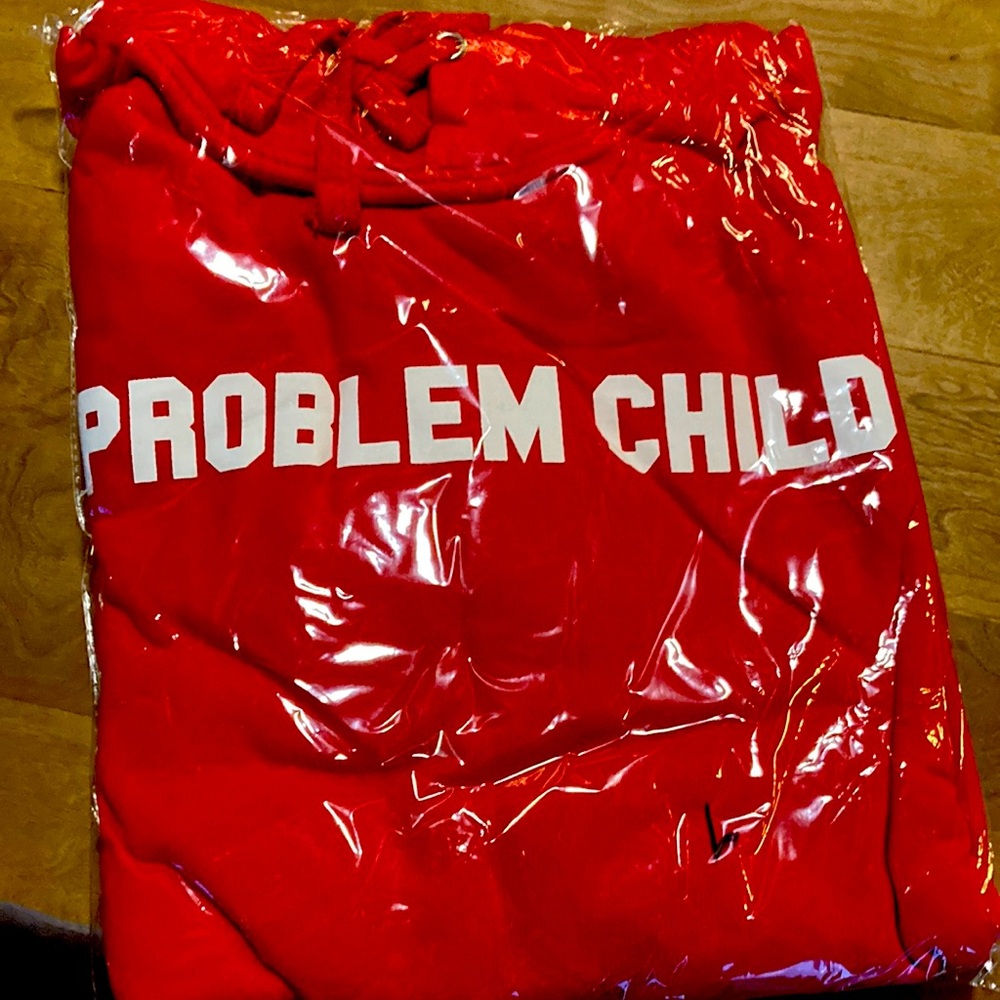 Red hoodie still in original packaging. Says….. PROBLEM CHILD